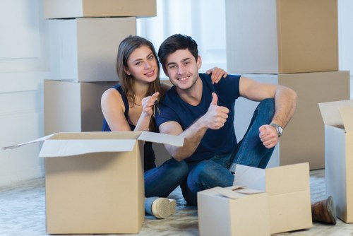 Local commercial movers handling desks and boxes in Kingston