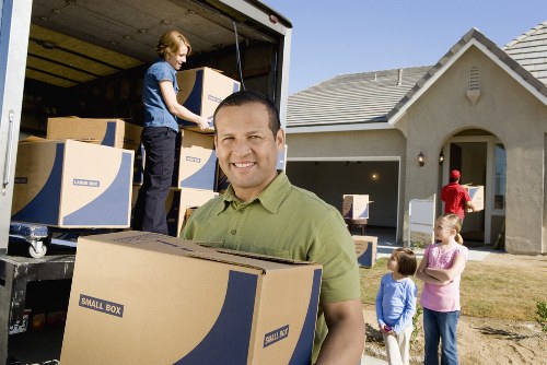 Careful packing of fragile household items for a move in Kingston